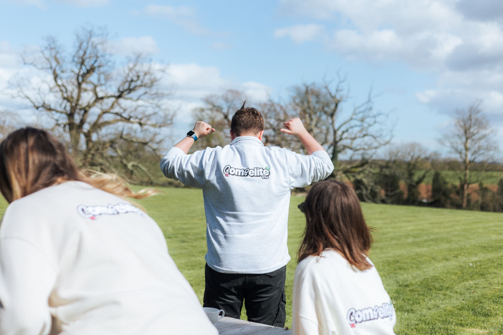 Compelite Pro team in branded sweatshirts outdoors