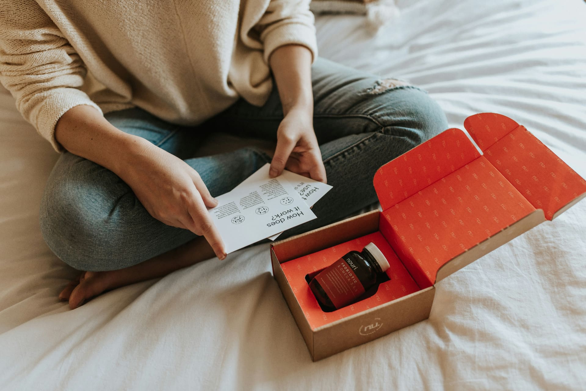 Customer unboxing a branded ecommerce subscription package — social media agency for ecommerce brands